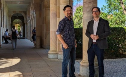 UQ School of Business students have worked through the hackathon with Jason Lowe of Oracle and Business Information Systems lecturer Dr Christoph Breidbach. two men stand by a pillar in a shady stone walkway